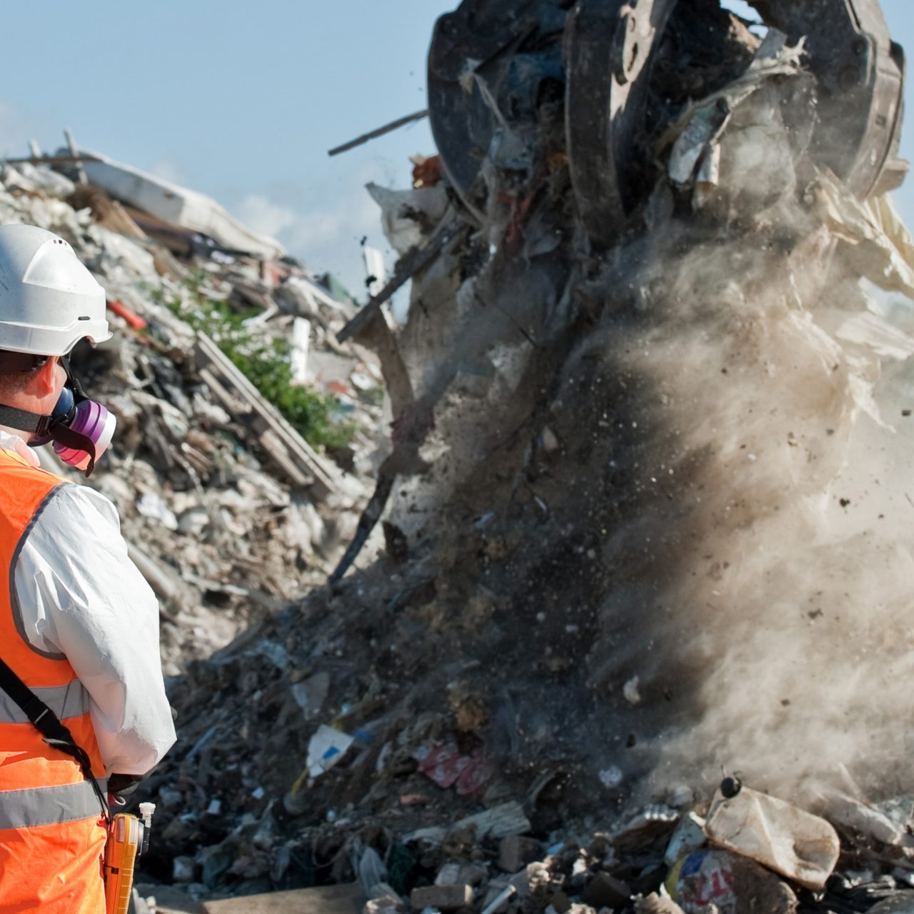 A pile of waste being grabbed by a claw