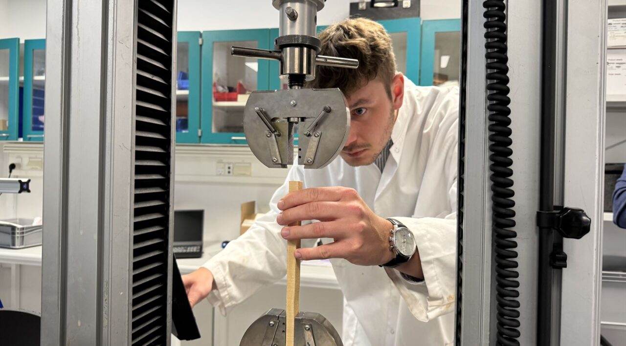 person in white lab coat in a laboratory wooden board
