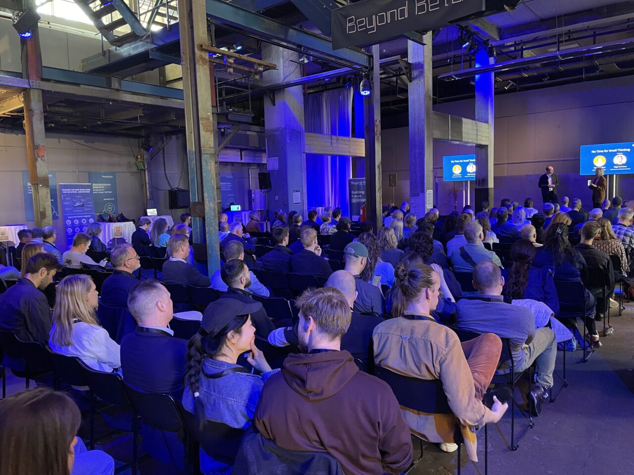 Participants at Beyond Beta Summit 2025, listening to a speak